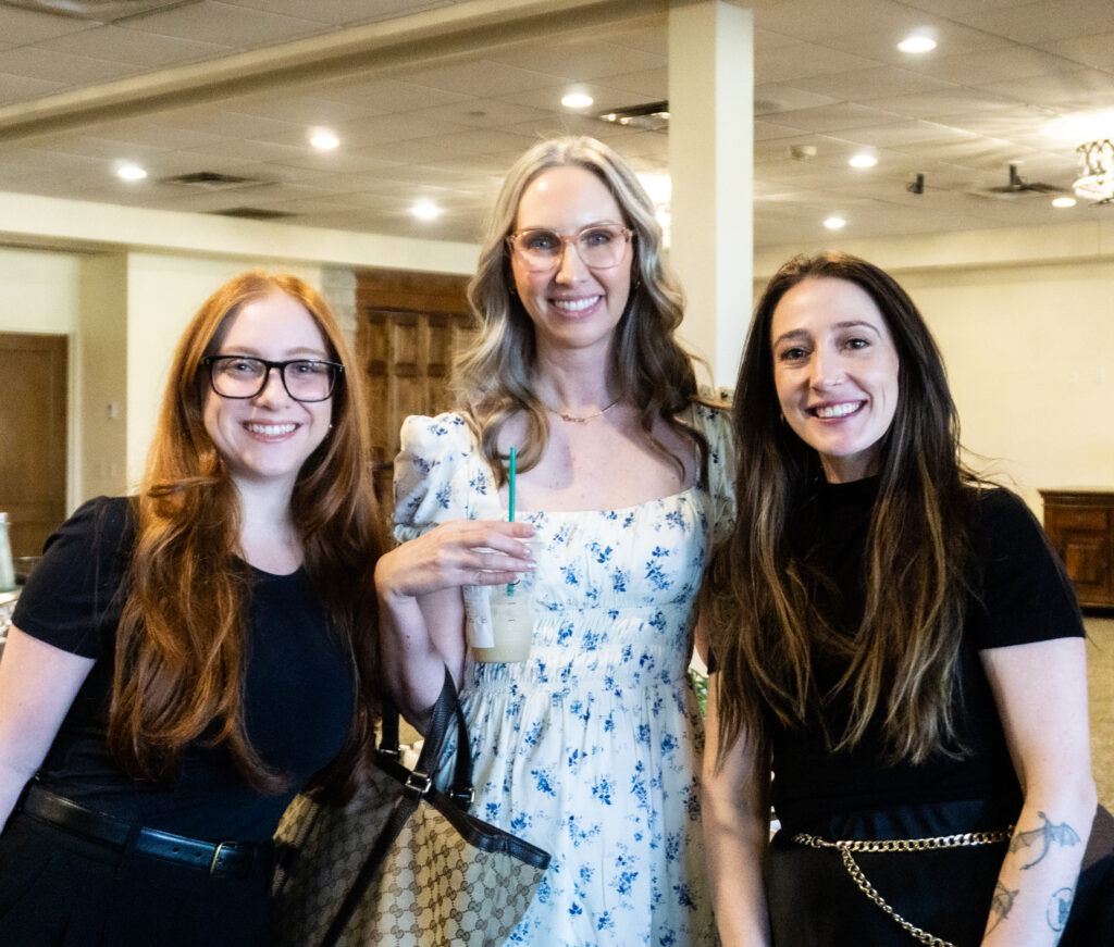 three women posing at the HELP STARTS HERE breakfast in 2025
