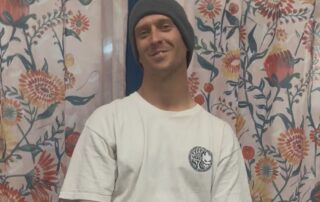 Client in front of floral curtains