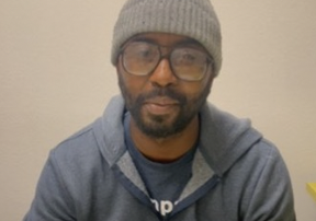 man with glasses and hat