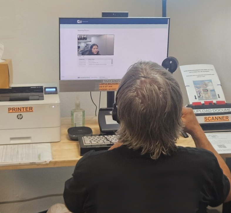 Person using the TeleMVD station to virtually chat with an MVD agent in order to obtain their ID