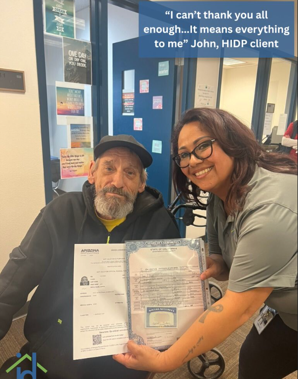 Client and employee displaying a birth certificate and social security card obtained thru the help of Justa Center and Homeless ID Project